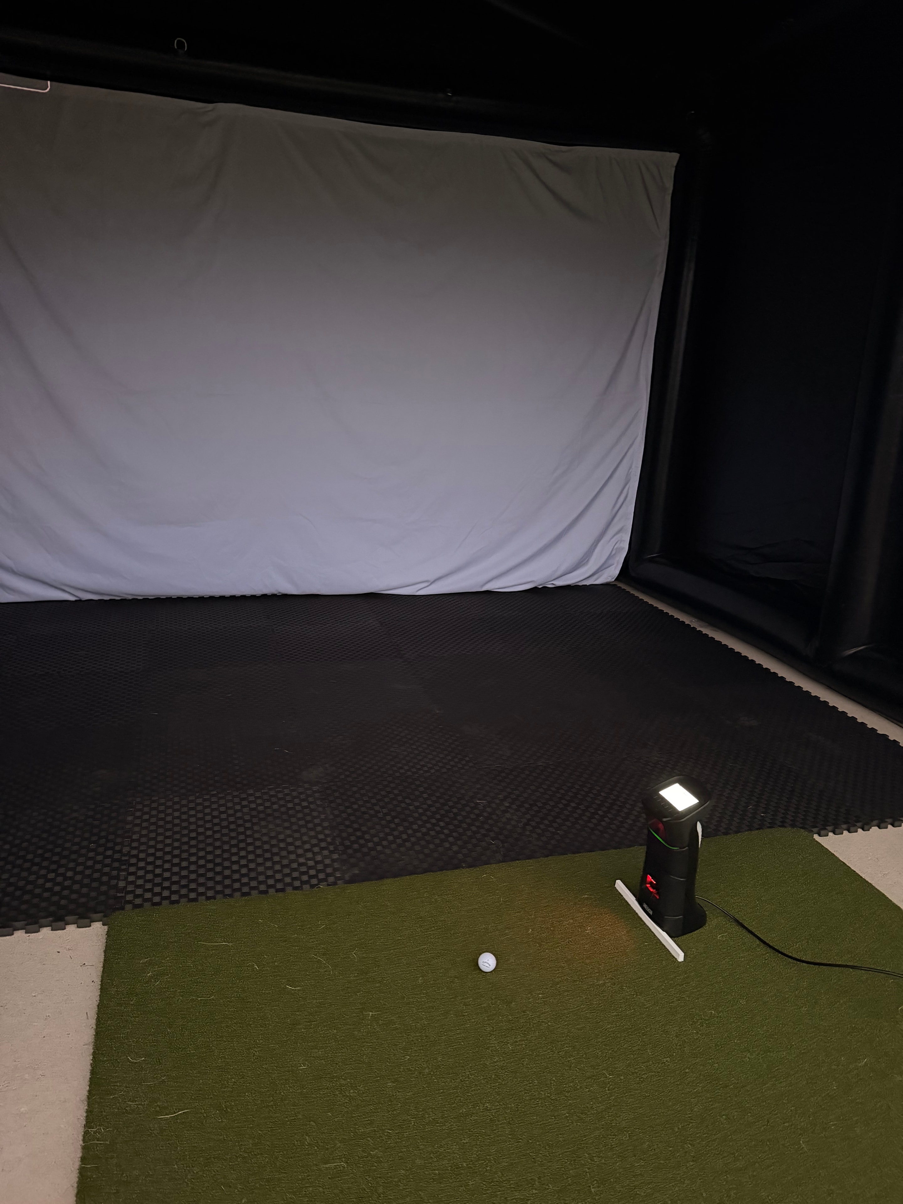 Player taking a swing on the simulator